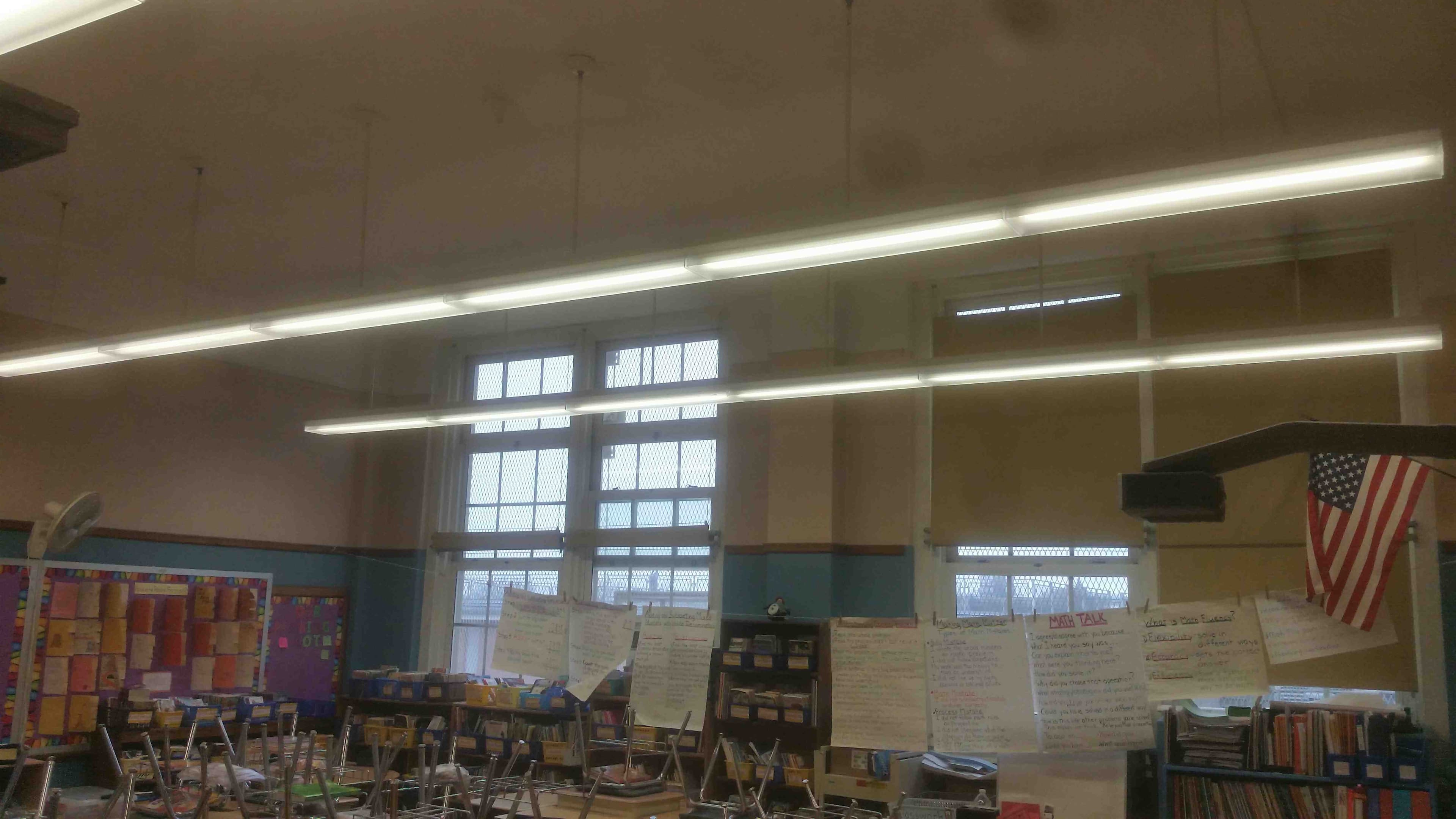 Newly installed hanging light fixtures in a school classroom