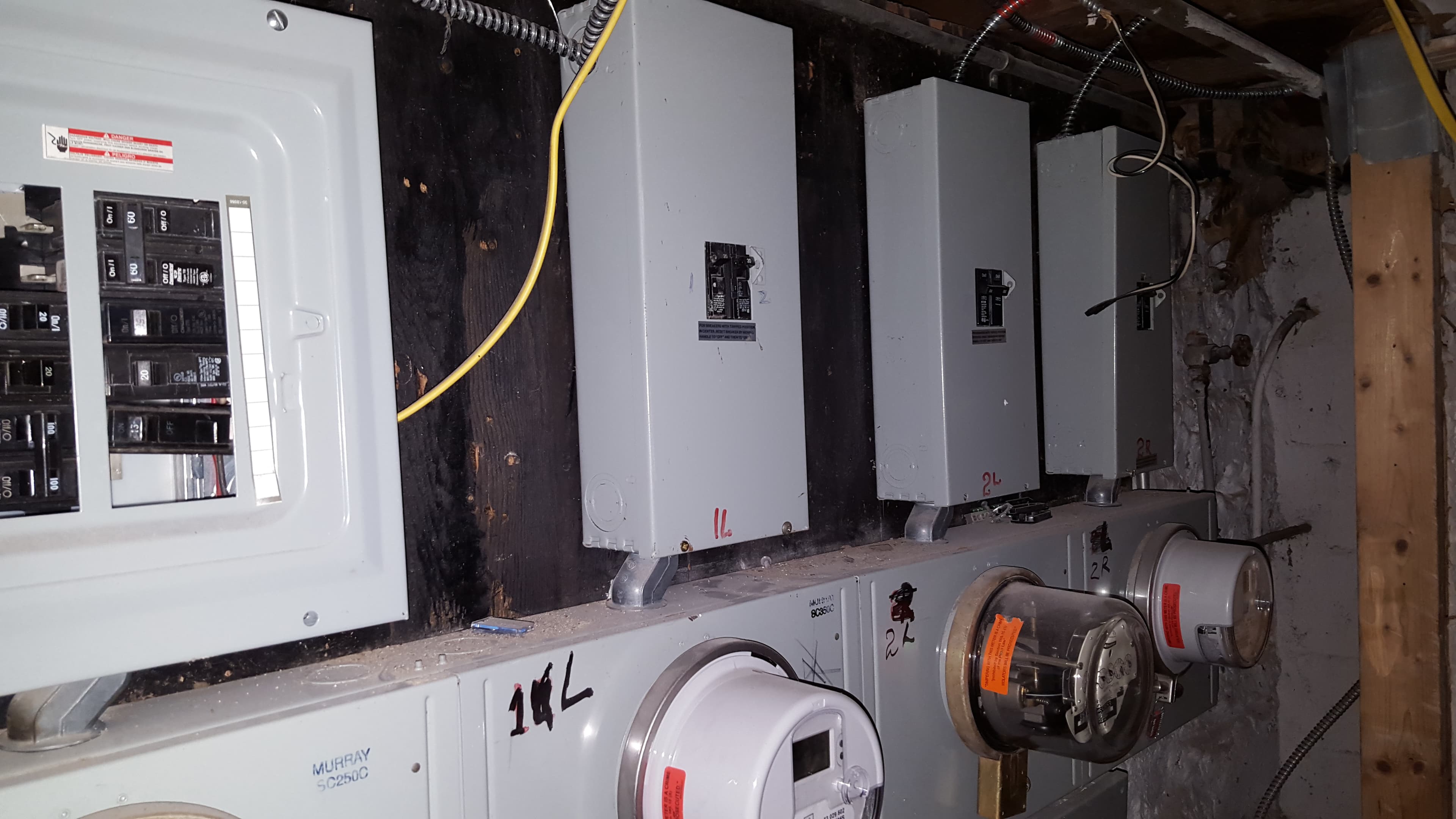 Wall of several electrical panels and meters