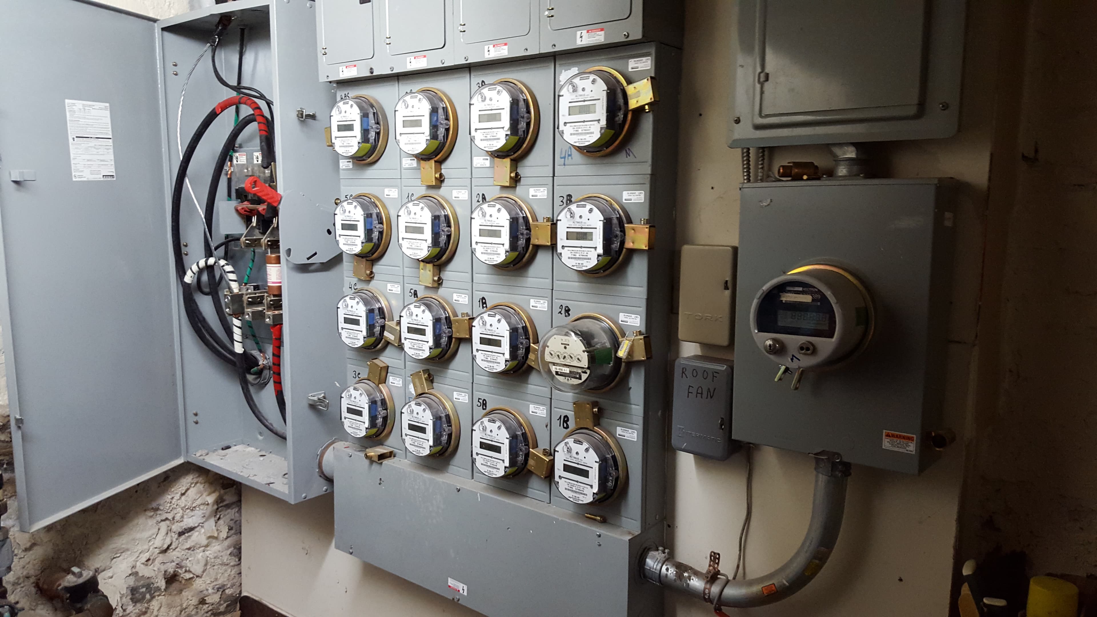 Wall of electrical meters and a large electrical fuse box